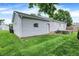 Exterior of the house with a green lawn, a back door, and a concrete patio at 6616 S Cross St, Pendleton, IN 46064