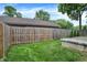Fenced backyard with lush green grass and mature trees offering a private outdoor space at 6616 S Cross St, Pendleton, IN 46064