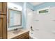 Bathroom featuring a shower and tub, vanity and mirror with bright lighting at 6616 S Cross St, Pendleton, IN 46064