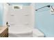 Bright bathroom with a tub-shower combo, white tile surround, and neutral vanity at 6616 S Cross St, Pendleton, IN 46064