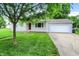 Charming single-story home features a well-manicured lawn, attached garage, and inviting front porch at 6616 S Cross St, Pendleton, IN 46064