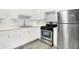 Well-lit kitchen featuring stainless steel appliances, white cabinetry, and granite countertops at 6616 S Cross St, Pendleton, IN 46064