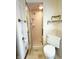 Bathroom with corner toilet and walk-in shower featuring gold hardware and ceramic tile at 7038 E 65Th St, Indianapolis, IN 46256