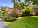 A well-maintained lawn and garden surrounds this charming home's exterior, complete with mature trees at 7038 E 65Th St, Indianapolis, IN 46256
