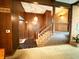 A charming hallway with wood paneling and a staircase leads to the home's upstairs living spaces at 7038 E 65Th St, Indianapolis, IN 46256