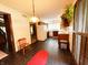 This vintage kitchen features wooden cabinets, modern appliances, and dark tiling, with an adjacent dining area at 7038 E 65Th St, Indianapolis, IN 46256