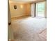 Open-concept living space with carpet, sliding doors, and a view of the backyard at 7038 E 65Th St, Indianapolis, IN 46256