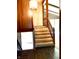 Carpeted staircase featuring wood railings and entry to the home's main living areas at 7038 E 65Th St, Indianapolis, IN 46256