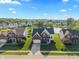 Serene aerial shot of a home in a community with a pond and fountain, surrounded by lush greenery at 7356 Woodington Pl, Indianapolis, IN 46259