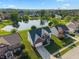 Aerial view of a neighborhood featuring a two-story home near a pond with a fountain at 7356 Woodington Pl, Indianapolis, IN 46259