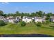 Aerial view of a home's backyard with a spacious lawn and view of a pond in a residential community at 7356 Woodington Pl, Indianapolis, IN 46259