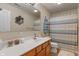 Updated bathroom featuring a single vanity, shower, and decorative accents at 7356 Woodington Pl, Indianapolis, IN 46259