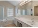 Bright bathroom featuring double sinks, soaking tub, and large mirror at 7356 Woodington Pl, Indianapolis, IN 46259