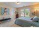 Comfortable bedroom featuring a large window and neutral decor at 7356 Woodington Pl, Indianapolis, IN 46259