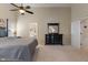 Large bedroom with gray carpet, black dresser, a doorway leading to the ensuite bathroom at 7356 Woodington Pl, Indianapolis, IN 46259
