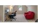 Spacious bedroom featuring an office space, a cozy red couch, and plush carpeting at 7356 Woodington Pl, Indianapolis, IN 46259