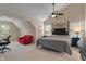 Spacious bedroom with a ceiling fan, red couch, neutral walls, and carpeted flooring at 7356 Woodington Pl, Indianapolis, IN 46259