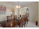 Traditional dining area showcasing a wood table and chairs with easy access to the kitchen and staircase at 7356 Woodington Pl, Indianapolis, IN 46259