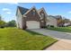 A charming home with a well-kept lawn, featuring brick accents and an attached two-car garage at 7356 Woodington Pl, Indianapolis, IN 46259