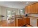 Traditional kitchen with wooden cabinets with a sink and an adjacent breakfast nook at 7356 Woodington Pl, Indianapolis, IN 46259