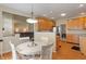 Open concept kitchen offers a bright breakfast nook with a white table and convenient access to the living room at 7356 Woodington Pl, Indianapolis, IN 46259