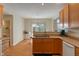 Traditional kitchen with wood cabinets, white appliances, and a sink with an adjacent breakfast nook at 7356 Woodington Pl, Indianapolis, IN 46259