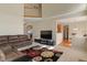 Bright and airy living room with a large television, a comfortable sofa and easy access to kitchen at 7356 Woodington Pl, Indianapolis, IN 46259