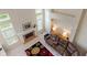Spacious living room with fireplace, sofa, and a large window offering abundant natural light at 7356 Woodington Pl, Indianapolis, IN 46259