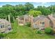 Aerial view showcases the homes' backyards and decks, with well-manicured lawns and mature trees at 7414 Harbour, Indianapolis, IN 46240