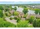 Aerial view showcases the neighborhood, surrounding lake, and lush greenery at 7414 Harbour, Indianapolis, IN 46240
