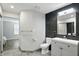 Bright bathroom with contemporary finishes, gray tile flooring, and updated vanity at 7414 Harbour, Indianapolis, IN 46240