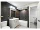 Well-lit bathroom showcasing dark tile accents, updated fixtures, and a bathtub at 7414 Harbour, Indianapolis, IN 46240