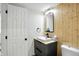 Modern bathroom featuring wood accent wall, floating vanity, and sleek fixtures at 7414 Harbour, Indianapolis, IN 46240