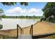 Picturesque view from stairs descending to a sandy beach by the tranquil lake and waterfront property at 7414 Harbour, Indianapolis, IN 46240