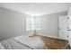 Bright bedroom with hardwood floors, neutral paint, and a large window at 7414 Harbour, Indianapolis, IN 46240