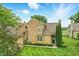 Inviting exterior of the property showcases lush greenery, a manicured lawn, and a detached garage at 7414 Harbour, Indianapolis, IN 46240