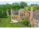 Aerial view showcases the home's back deck and mature trees at 7414 Harbour, Indianapolis, IN 46240