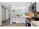 Open kitchen design with a view into the living room, stainless steel appliances, and white cabinets at 7414 Harbour, Indianapolis, IN 46240
