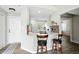 Kitchen view featuring the island seating, and a glimpse into the living area at 7414 Harbour, Indianapolis, IN 46240