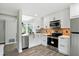 A bright kitchen has stainless appliances, white cabinets, and tile backsplash at 7414 Harbour, Indianapolis, IN 46240