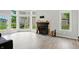 Living room has a brick fireplace and large windows overlooking the backyard and a door to the outside at 7414 Harbour, Indianapolis, IN 46240