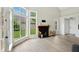 Open-plan living room featuring large windows, and a cozy fireplace, perfect for gatherings at 7414 Harbour, Indianapolis, IN 46240