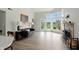 Bright living room features a fireplace, tall ceilings, and a large window with a view of the yard at 7414 Harbour, Indianapolis, IN 46240