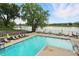 Inviting community pool area with lounge chairs and picturesque lakeside views at 7414 Harbour, Indianapolis, IN 46240