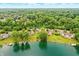 Breathtaking waterfront homes on a serene lake surrounded by a vibrant green landscape at 7414 Harbour, Indianapolis, IN 46240