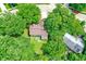 Home with a deck nestled among green trees, offering privacy, as viewed from above at 7720 Langwood Dr, Indianapolis, IN 46268