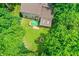Aerial view of a backyard featuring a deck, manicured lawn, and a cozy fire pit area at 7720 Langwood Dr, Indianapolis, IN 46268