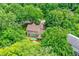 Aerial shot of a home’s backyard with a deck and lush greenery surrounding the property at 7720 Langwood Dr, Indianapolis, IN 46268
