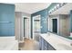 Modern bathroom with double sinks, bathtub and walk-in shower at 7720 Langwood Dr, Indianapolis, IN 46268