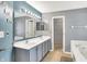 Bathroom featuring double sinks, a large mirror, and bathtub at 7720 Langwood Dr, Indianapolis, IN 46268